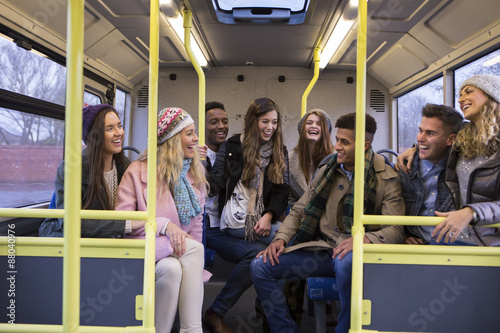 Young people travelling by bus together.