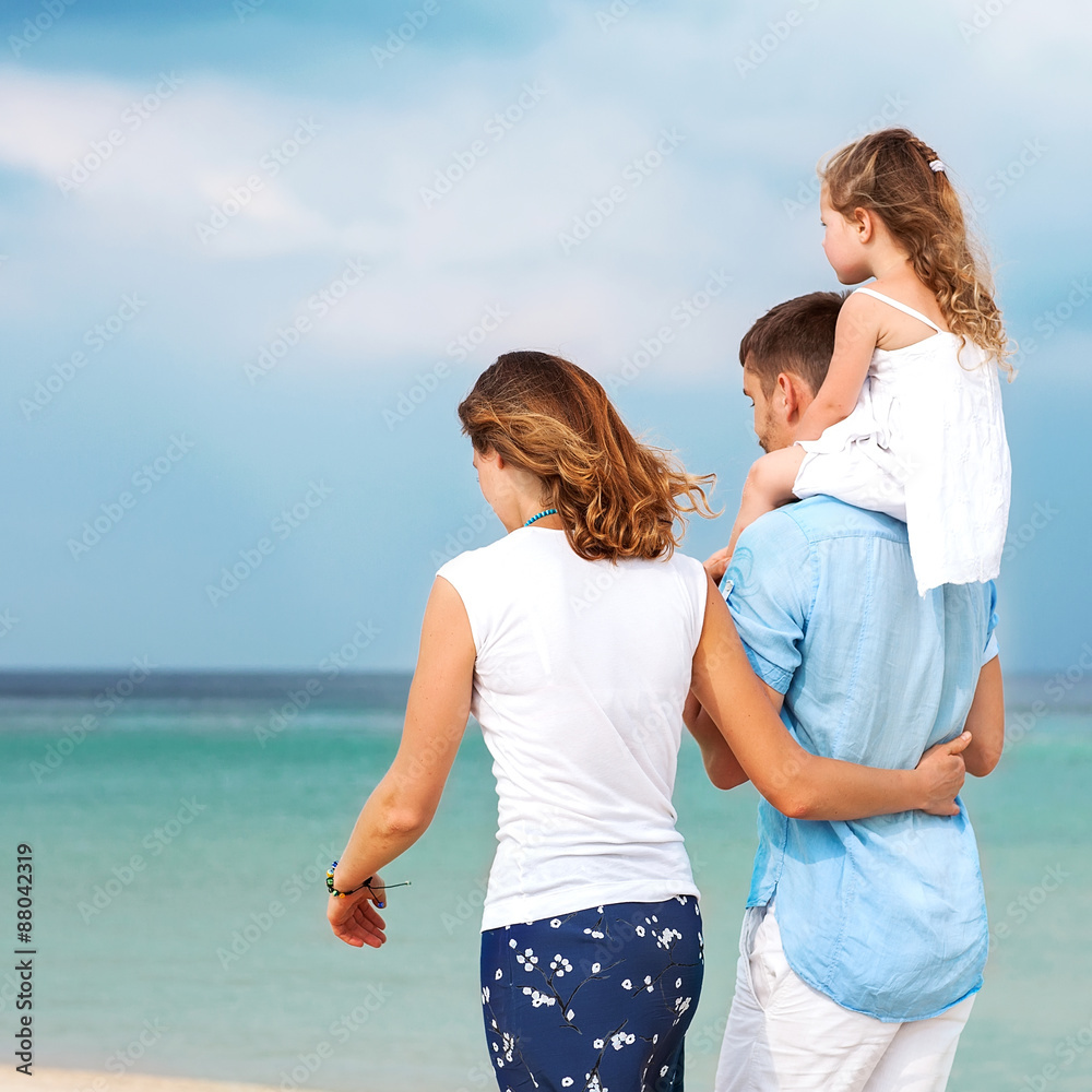 happy family walking on the sea on the beach happy family walking on the sea on the beach