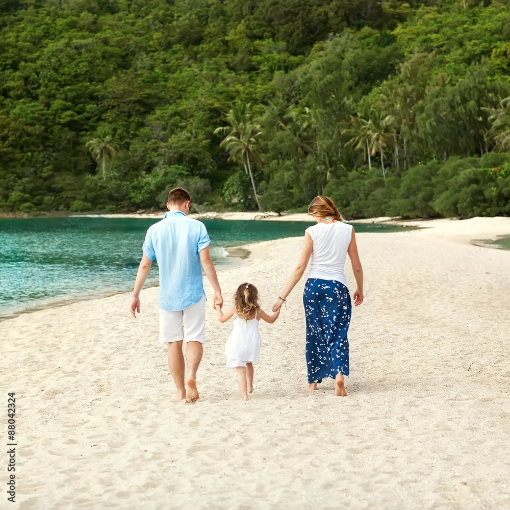 happy family walking on the sea on the beach happy family walking on the sea on the beach
