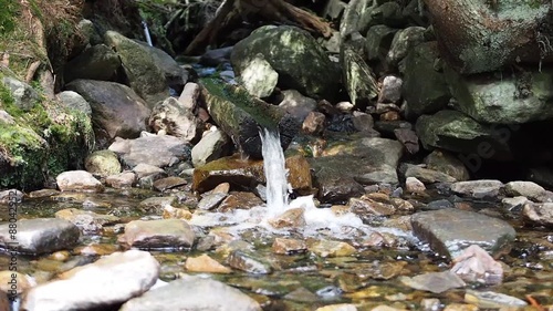 Water flowing from wooden pipe, fountain, waterplace photo