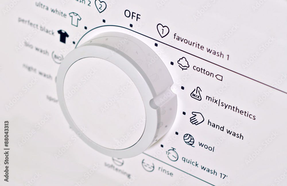 Close up on synthetics button on control panel of washing machine Close up on synthetics button on control panel of washing machine