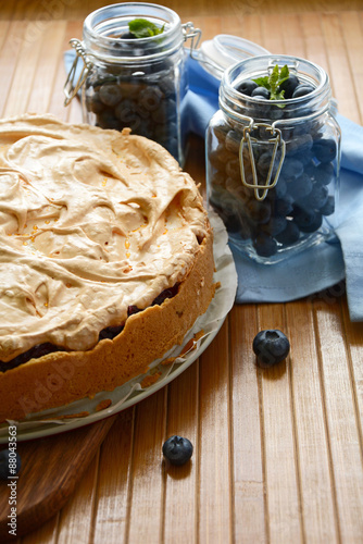 Homemade cake with blueberries on wooden background