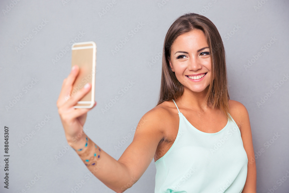 Smiling girl making selfie photo on smartphone Smiling girl making selfie photo on smartphone