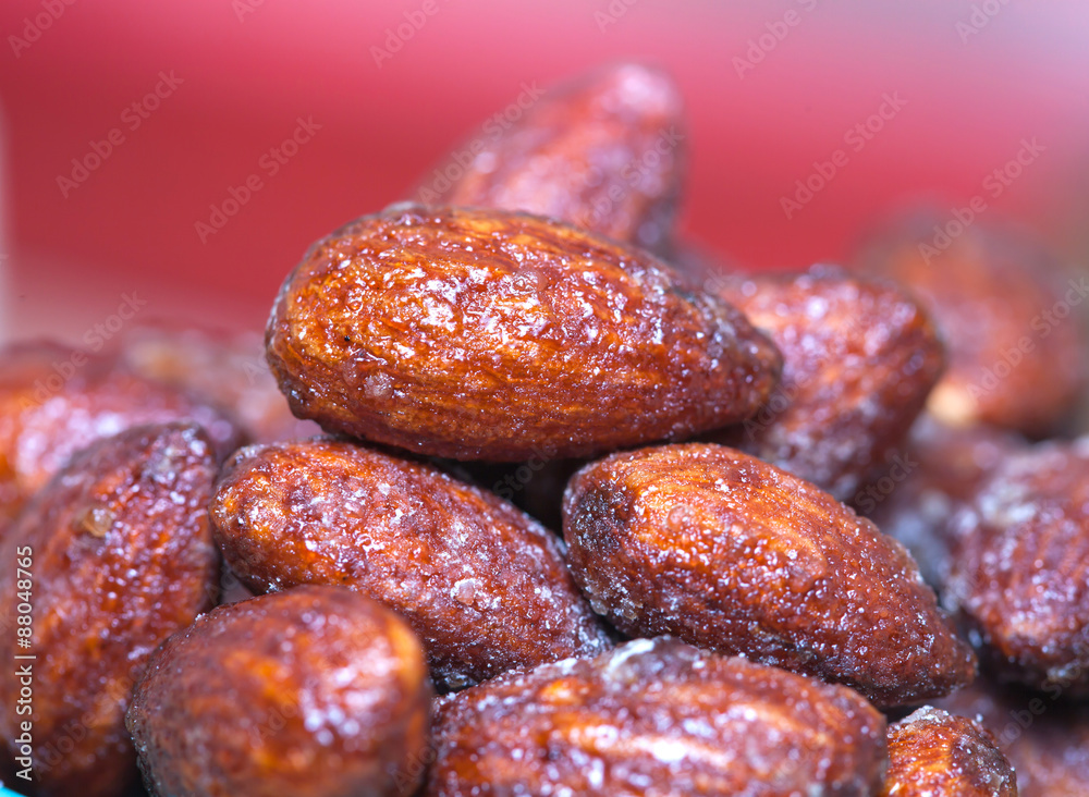Almonds caramel in cup on table. Selective focus, shallow DOF Almonds caramel in cup on table. Selective focus, shallow DOF