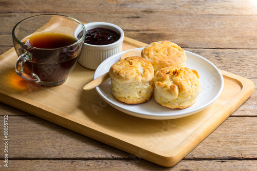 Home made orange english biscuit with blackberry jam and black coffee.