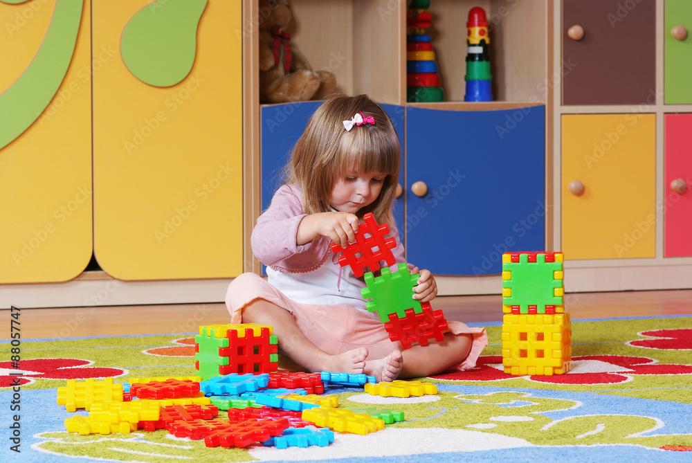 Two-year girl playing and learning in preschool Two-year girl playing and learning in preschool