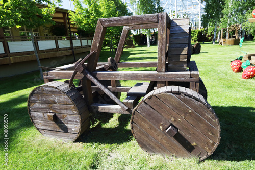 Wooden cart with a steering wheel.