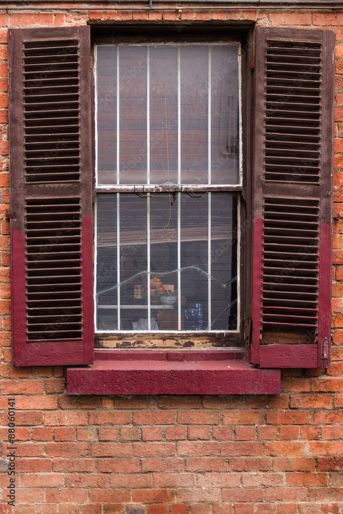 Obraz premium Window with Worn Out Wooden Shutters