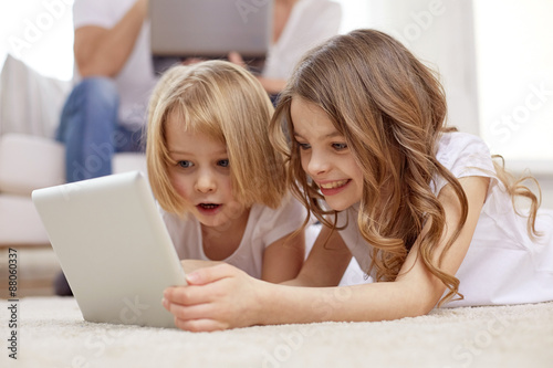 happy little girls with tablet pc computer at home © Syda Productions