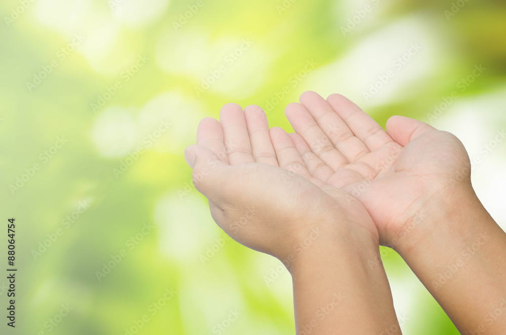open hand on blurred abstract nature background - concept help open hand on blurred abstract nature background - concept help