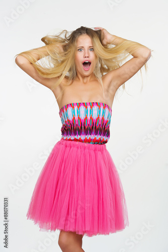 Attractive young woman in fancy pink dress got her hair messed up
