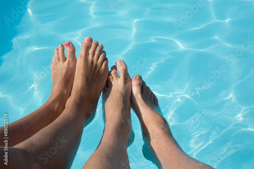feet of couple near swimming pool concept vacation holidays foot