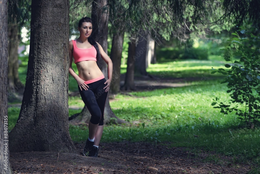 Portrait of fashion fitness model posing in park Portrait of fashion fitness model posing in park