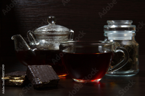 Cup with tea and teapot