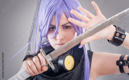 Foto Female fantasy warrior / Female warrior with sword isolated on the gray backgrou