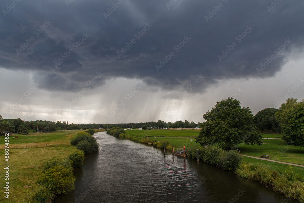 Winsen (Aller), Germany - July 29, 2015: Photograph of the river Aller and an approaching summer storm.