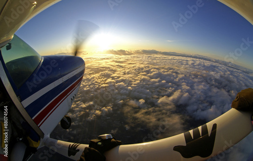 Sunset airplane above the clouds