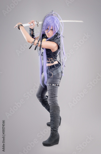 Obraz na płótnie Female fantasy warrior / Female warrior with sword isolated on the gray backgrou