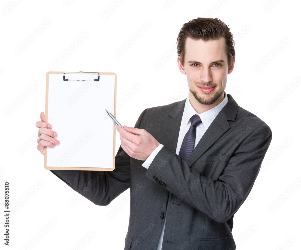Young businessman with pen point to clipboard Young businessman with pen point to clipboard