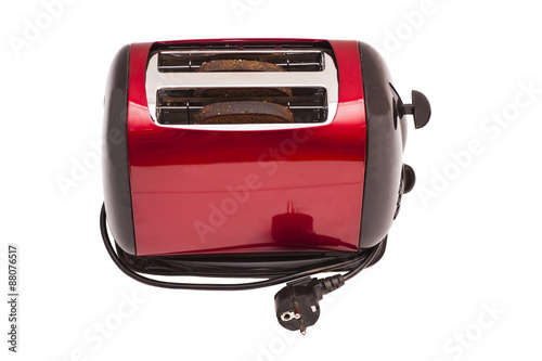 Red toaster and two slices of bread isolated on white