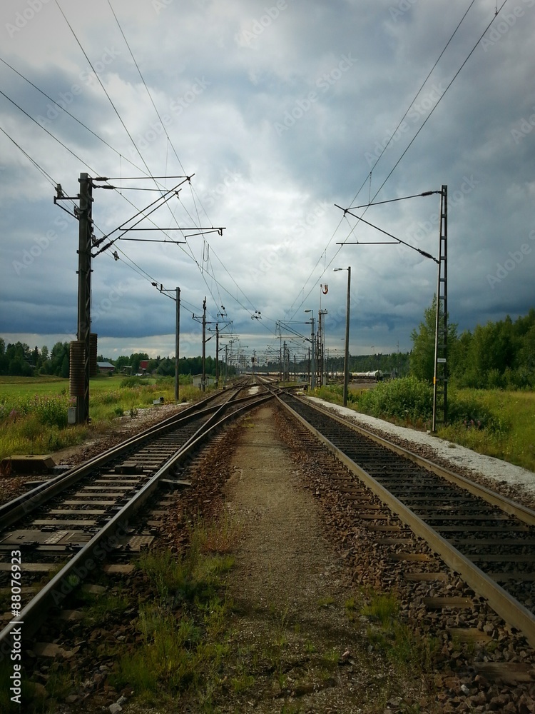 Railway shunting yard. Rail tracks and switches on cloudy summer day.