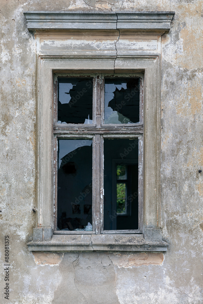 Old window of a ruined wall of an old manor house in a small village in Poland.