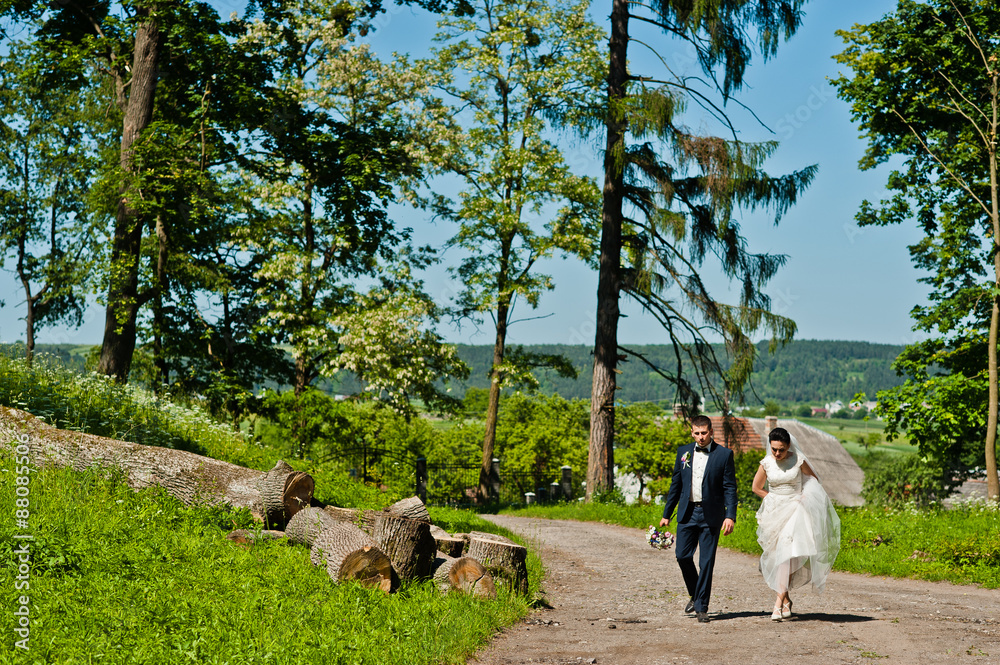 Obraz premium Gorgeus wedding couple on green sunny forest