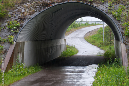 Tunnel for bicycles and bicycle path on a rainy summer day.