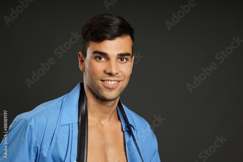 Young businessman in blue shirt with strap around his neck, right you can write some text