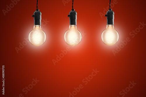 Idea concept - Vintage incandescent bulbs on red background