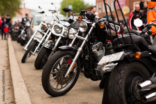 A number of motorbike bikers in the city.