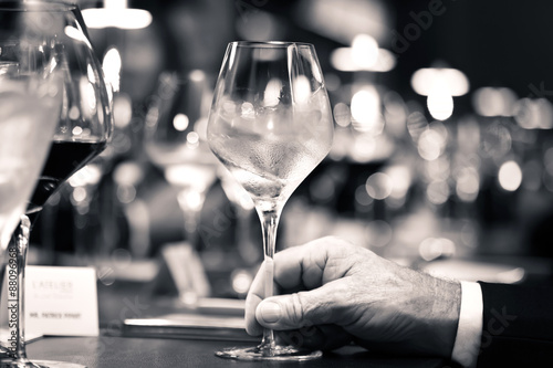 black and white of white wine on hand with dinner on restaurant
