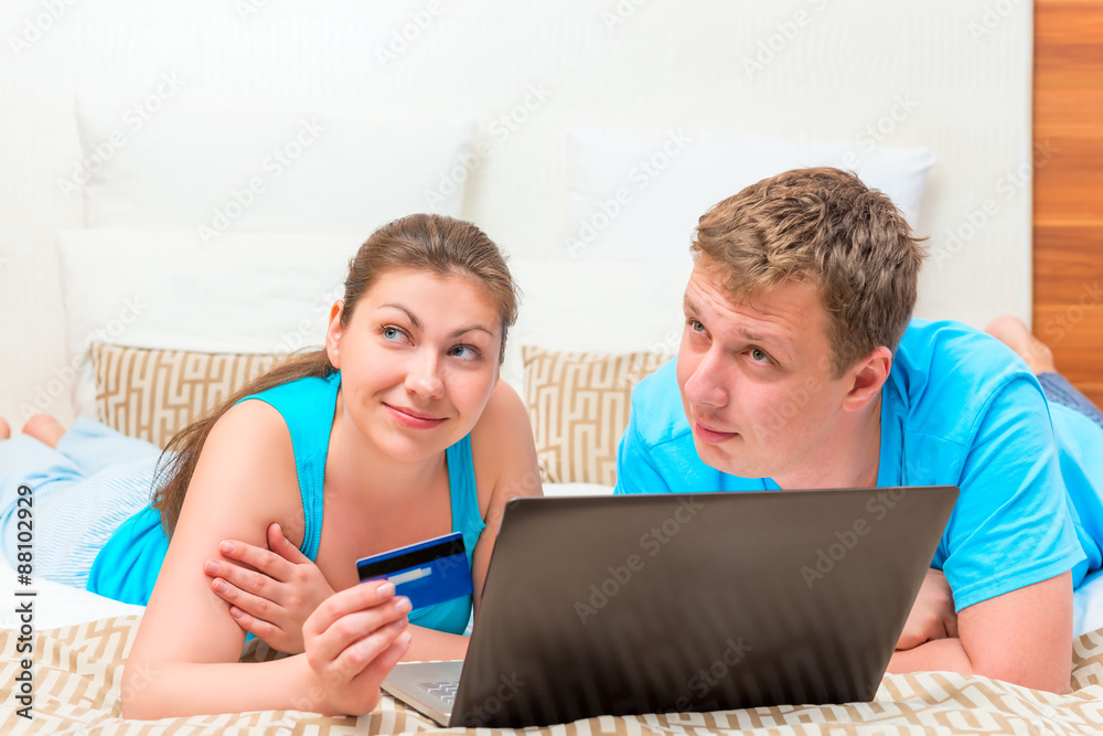 dreamy happy couple with a credit card to shop online dreamy happy couple with a credit card to shop online