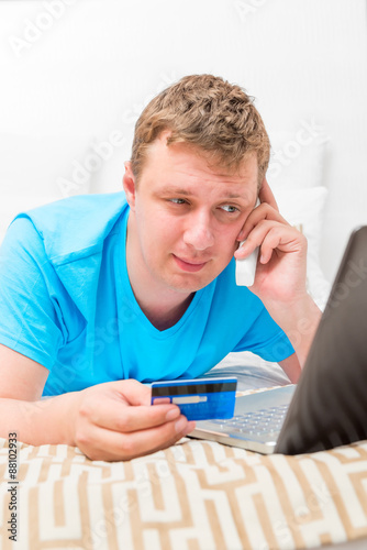 portrait of a man with a credit card and a laptop © kosmos111