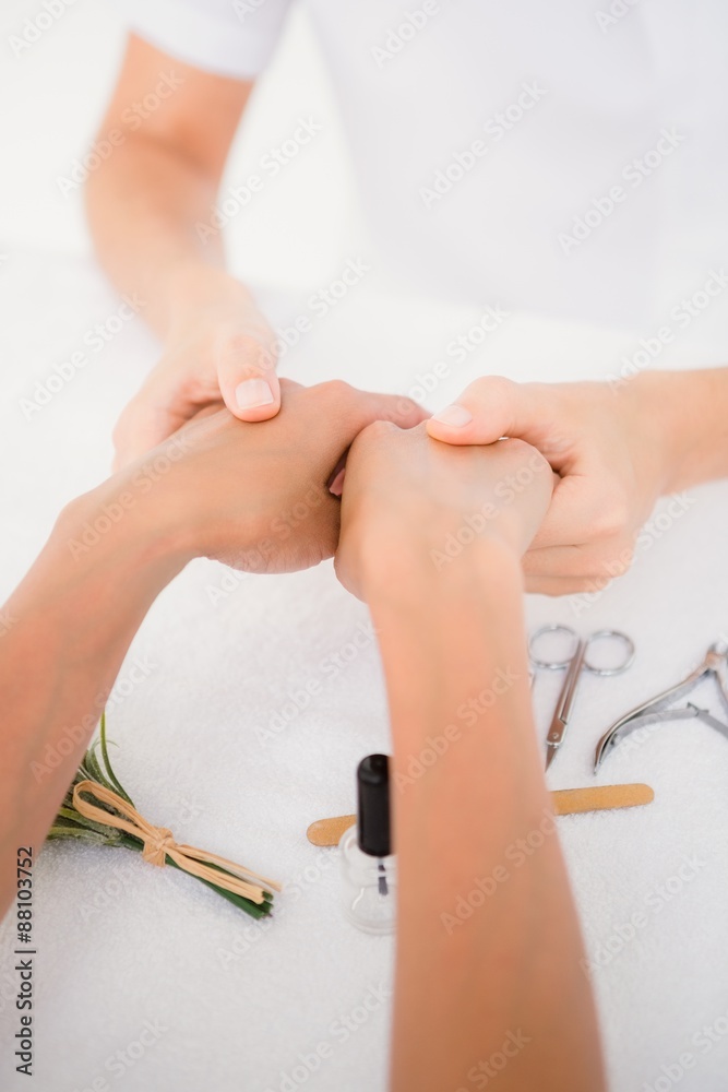 Beautician filing female clients nails at spa beauty salon Beautician filing female clients nails at spa beauty salon