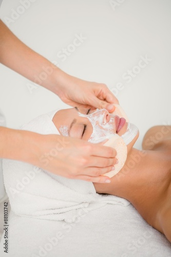 Hand cleaning womans face with cotton swabs with side view 