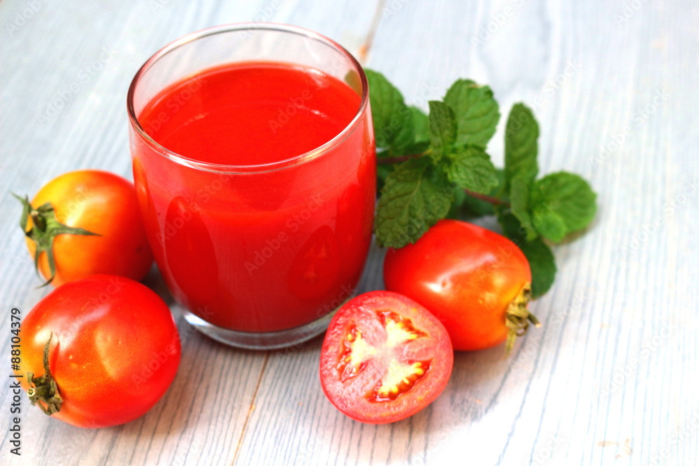 Glass of tomato juice with fresh tomatoes Glass of tomato juice with fresh tomatoes