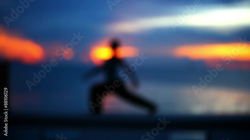 Wallpaper Mural Girl doing yoga at sunset. Blurred background.  Torontodigital.ca
