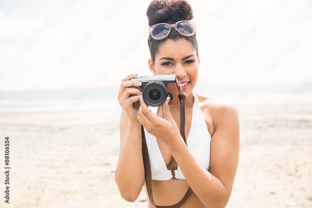 Pretty hipster in bikini taking picture