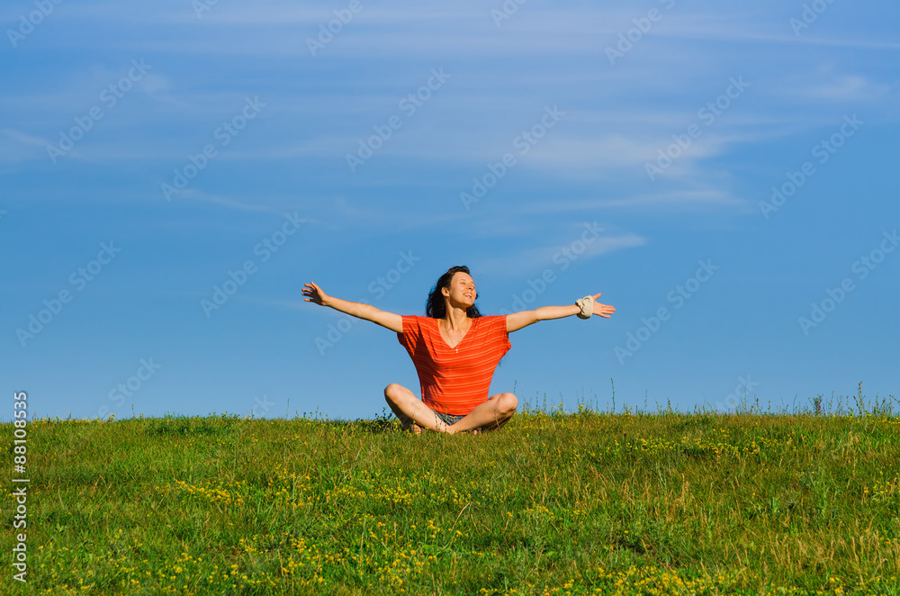 happy relaxing woman sitting on green grass happy relaxing woman sitting on green grass