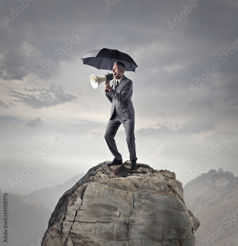 Businessman screaming into a megaphone