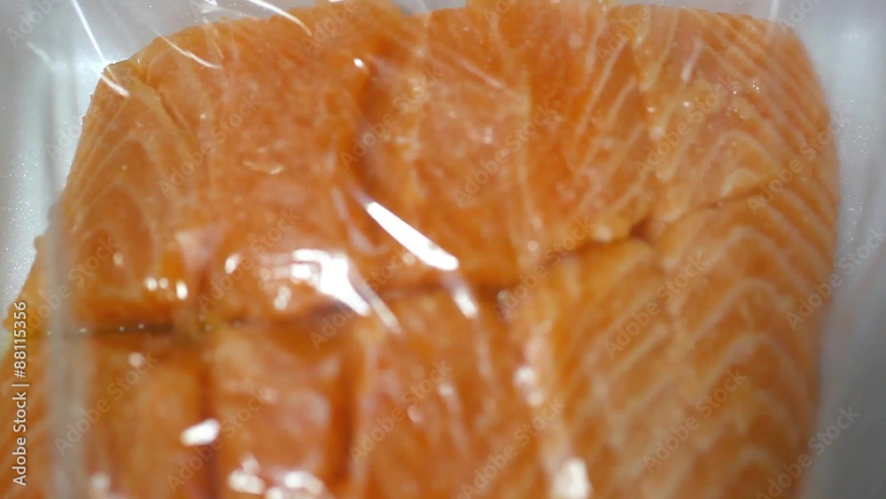 packaging salted salmon in plastic wrap. packaging salted salmon in plastic wrap.