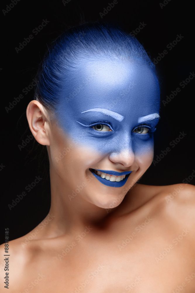 Portrait of a woman who is posing covered with blue paint Portrait of a woman who is posing covered with blue paint