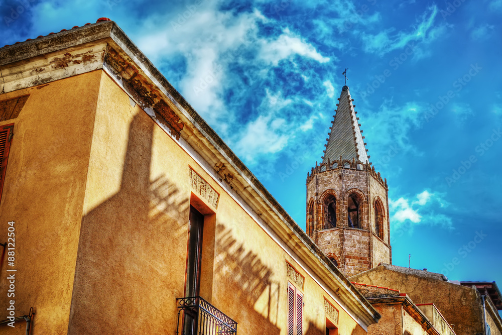 Fototapeta premium Duomo steeple under clouds in Alghero