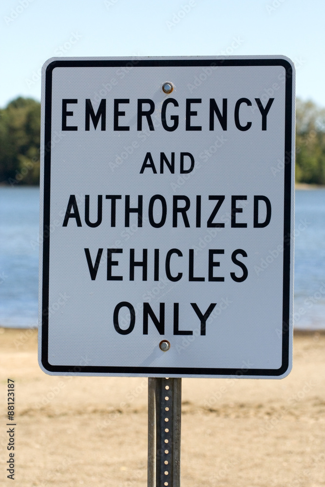 Emergency and Authorized Vehicles Only Sign – An emergency sign on the beach.