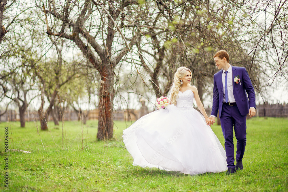 Wedding portrait of the bride and groom in the spring garden