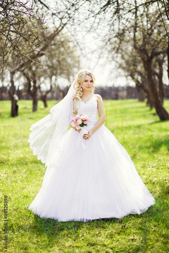 young, beautiful bride with a bouquet, is the spring, apple orch young, beautiful bride with a bouquet, is the spring, apple orch