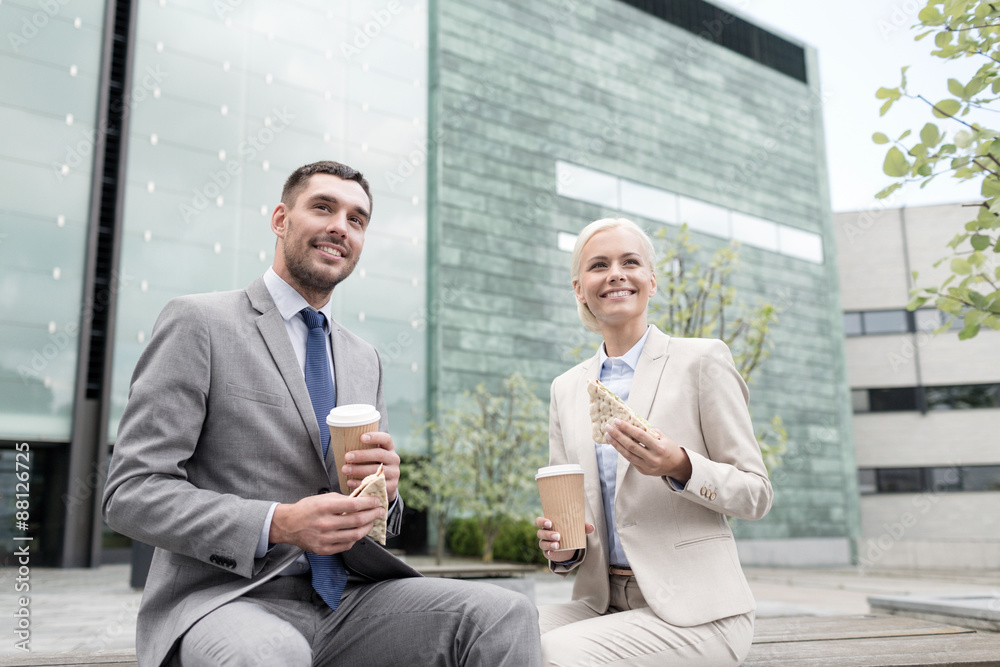 smiling businessmen with paper cups outdoors smiling businessmen with paper cups outdoors