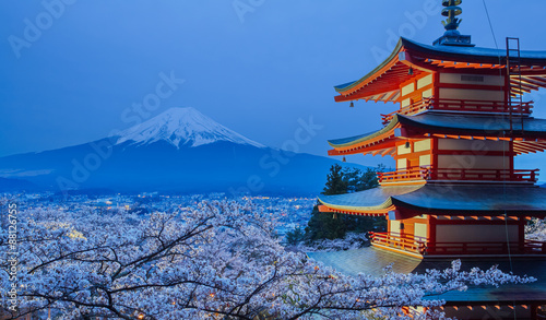 Mountain Fuji and red pagoda evening light up in cherry blossom sakura season
