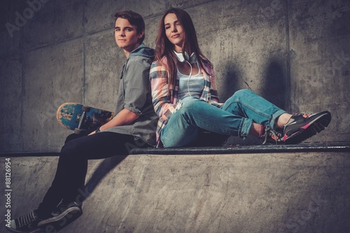 Young couple with skateboard outdoors